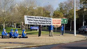 '图：学员在中领馆前拉起横幅抗议'