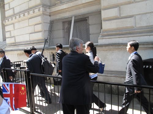 图5：西人法轮功学员泽克用简单汉语告诉李克强的随从人员法轮大法好，并劝他们退<span