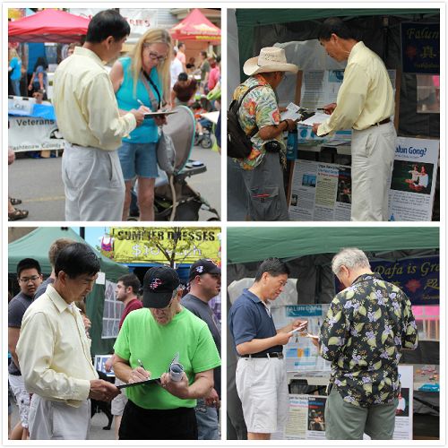 安娜堡艺术节上,人们驻足聆听法轮功真相并签名反对迫害