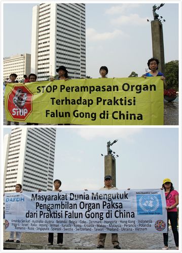 法轮功学员在市中心揭露中共邪<span