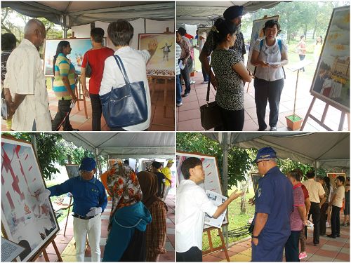 图2: 法轮功团体展出的“真善忍国际美展”吸引了许多民众前来观赏,图为学员在为观众讲解