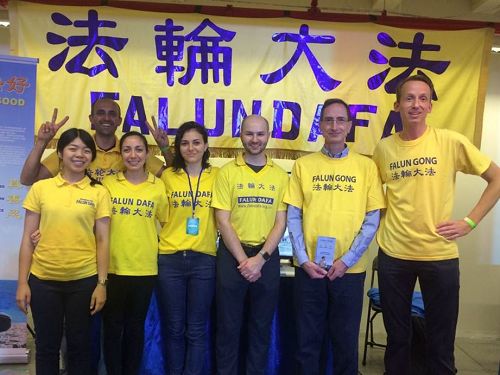 '图8:中西方法轮功学员在大横幅前合影'