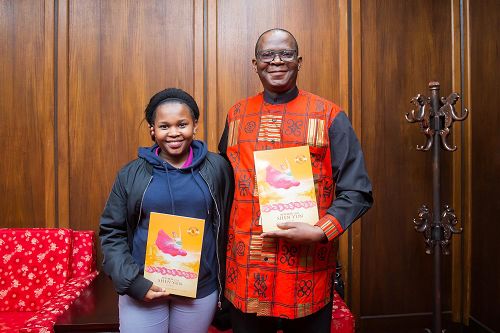 南非驻台代表麦哲培(Seraki Matsebe)(右)与女儿观赏神韵国际艺术团在台北国父纪念馆的演出。