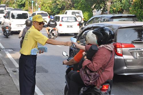 '图6~7:泗水市部份法轮功学员在路边展开反迫害横幅并发送真相资料'