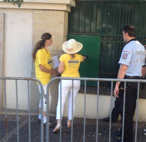 '图7:法轮功学员们代表将公开信投入了中国大使馆的信箱'