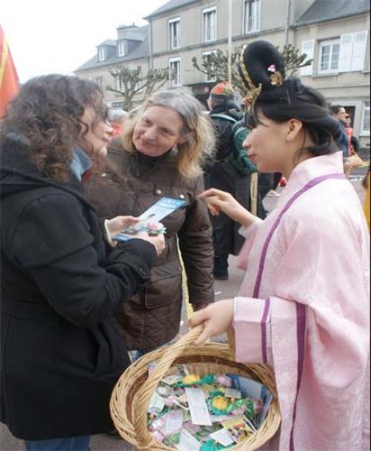 '图3:法轮功学员向观看游行的观众介绍功法。'