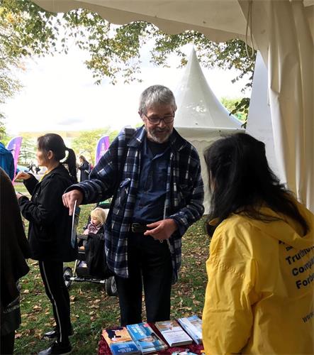 '图1～2：民众到法轮功信息帐篷前咨询'