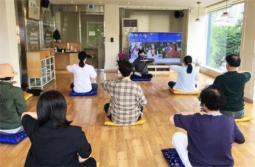 '图1：参加六月份法轮大法九天班（上午班）的新学员们正在学习法轮大法第五套功法--神通加持法。'