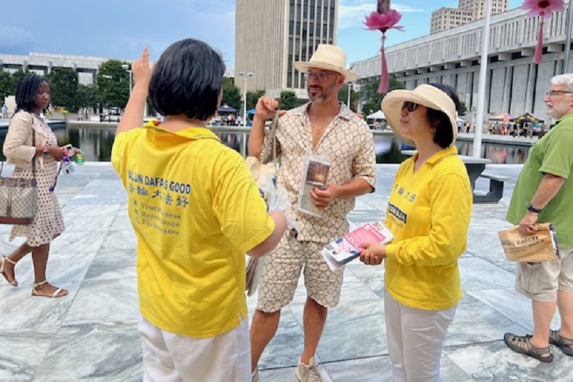 图7:企业主丹尼尔认真聆听法轮功学员讲真相。他深深认同真、善、忍的法理。