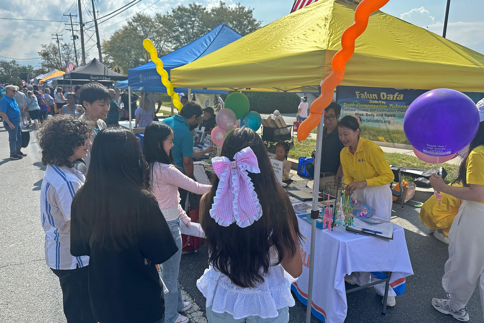 图8:很多人在展位前了解法轮大法的真相。